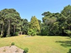 Relax in the enclosed gardens edged with woodland
