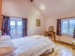 Spacious bedroom with king-size bed, dual aspect windows and far reaching views Spacious bedroom with king-size bed, dual aspect windows and far reaching views