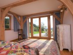 Ground floor bedroom with French doors leading to the decked area Ground floor bedroom with French doors leading to the decked area