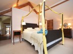 The large four-poster bed takes centre stage