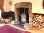 Cosy up infront of the large wood burner in the lounge