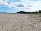 Stroll onto the fabulous beach at Llansteffan with castle overlooking