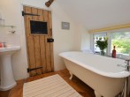 Bathroom on the first floor with a roll top bath overlooking the rear garden