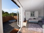 The open-plan studio-style interior opens out to the raised decking The open-plan studio-style interior opens out to the raised decking