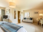 Beautifully appointed bedroom with seating area and TV Beautifully appointed bedroom with seating area and TV