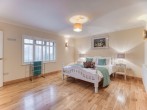 Light floods in the spacious ground floor double bedroom with en-suite