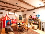 Children’s playroom with abundance of toys and dressing-up box Children’s playroom with abundance of toys and dressing-up box