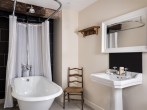 Pen-y-Crug bedroom large en-suite bathroom with a deep roll top bath Pen-y-Crug bedroom large en-suite bathroom with a deep roll top bath